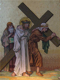 Image of Fifth Station: Simon of Cyrene helps Jesus to carry his cross.